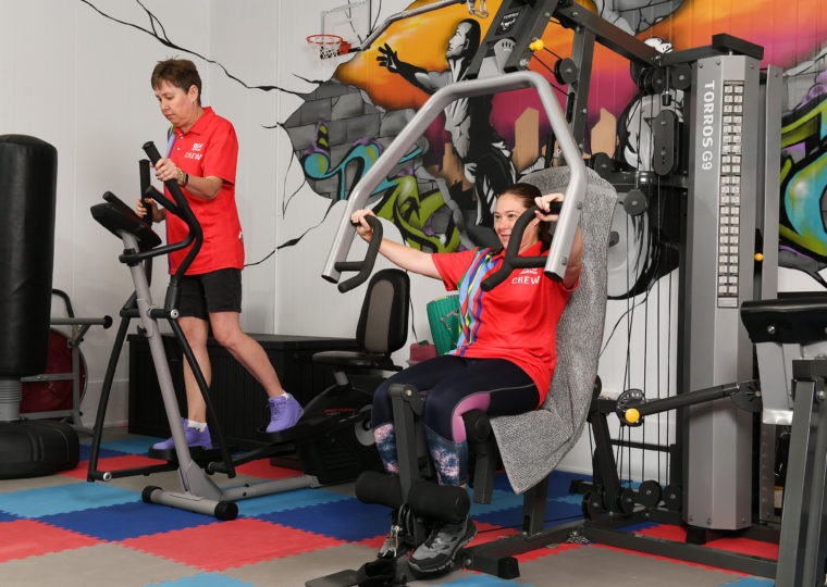Two People on exercise equipment
